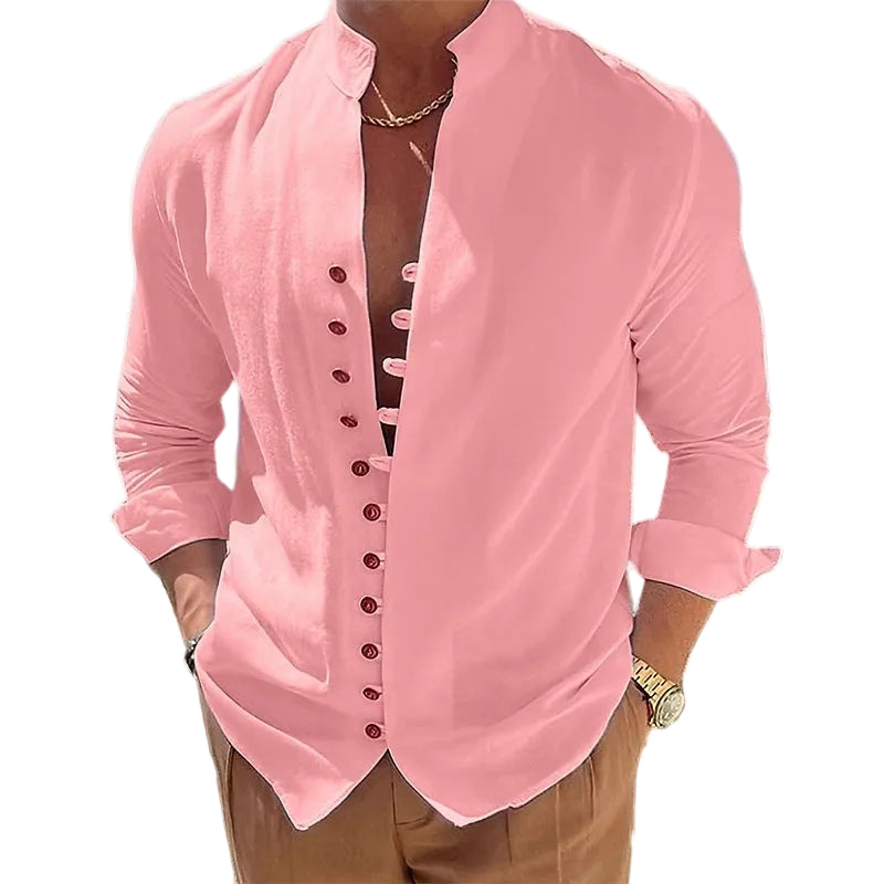 Person wearing a pink button-up shirt with a scenic background