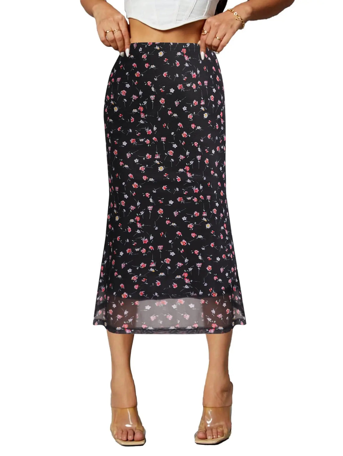 Black floral skirt worn by a person on a white background