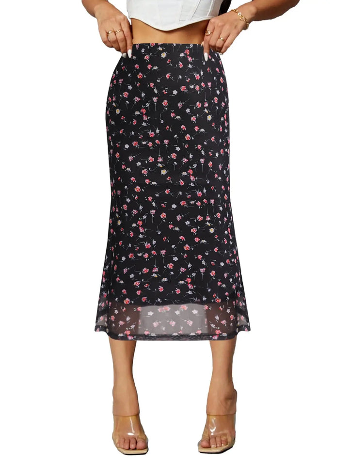 Black floral skirt worn by a person on a white background