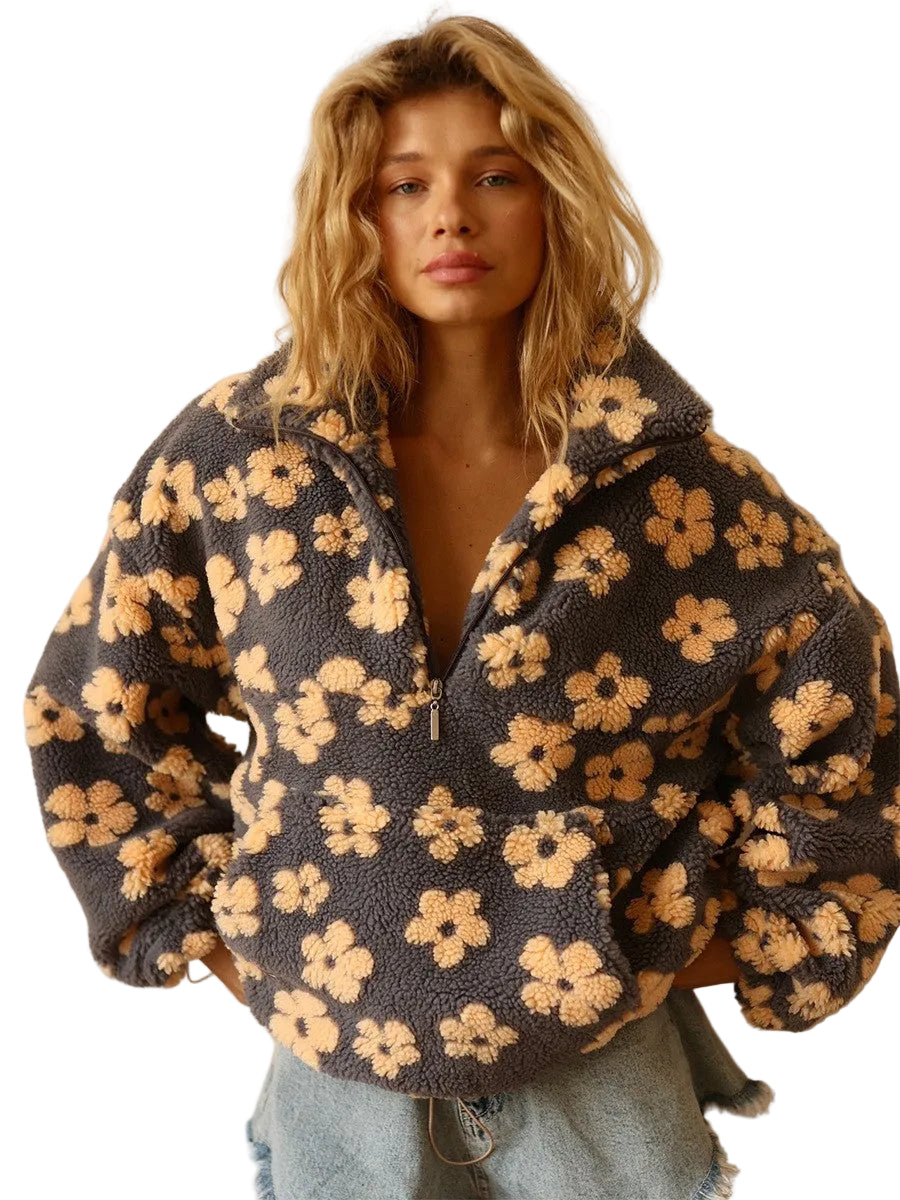 Woman wearing a floral patterned jacket against a neutral background