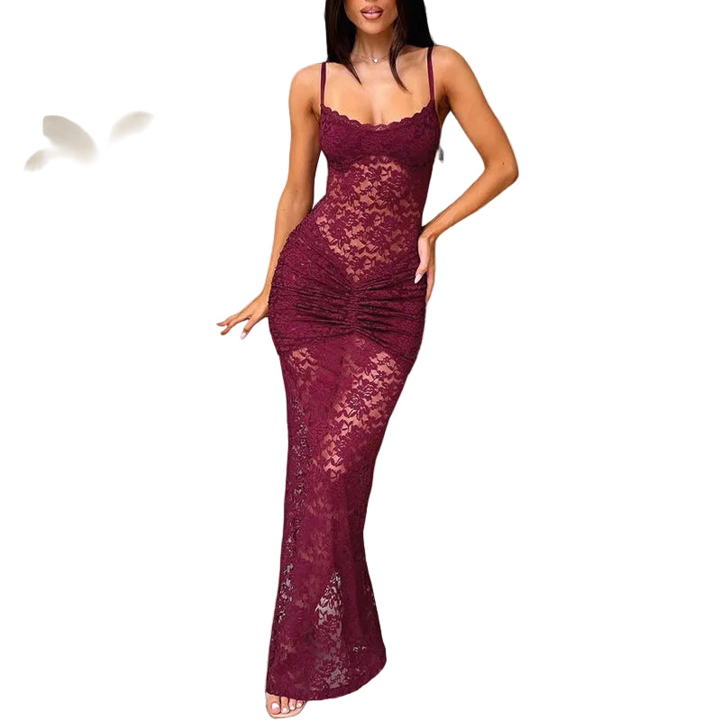 Woman wearing a burgundy lace dress in an elegant room.