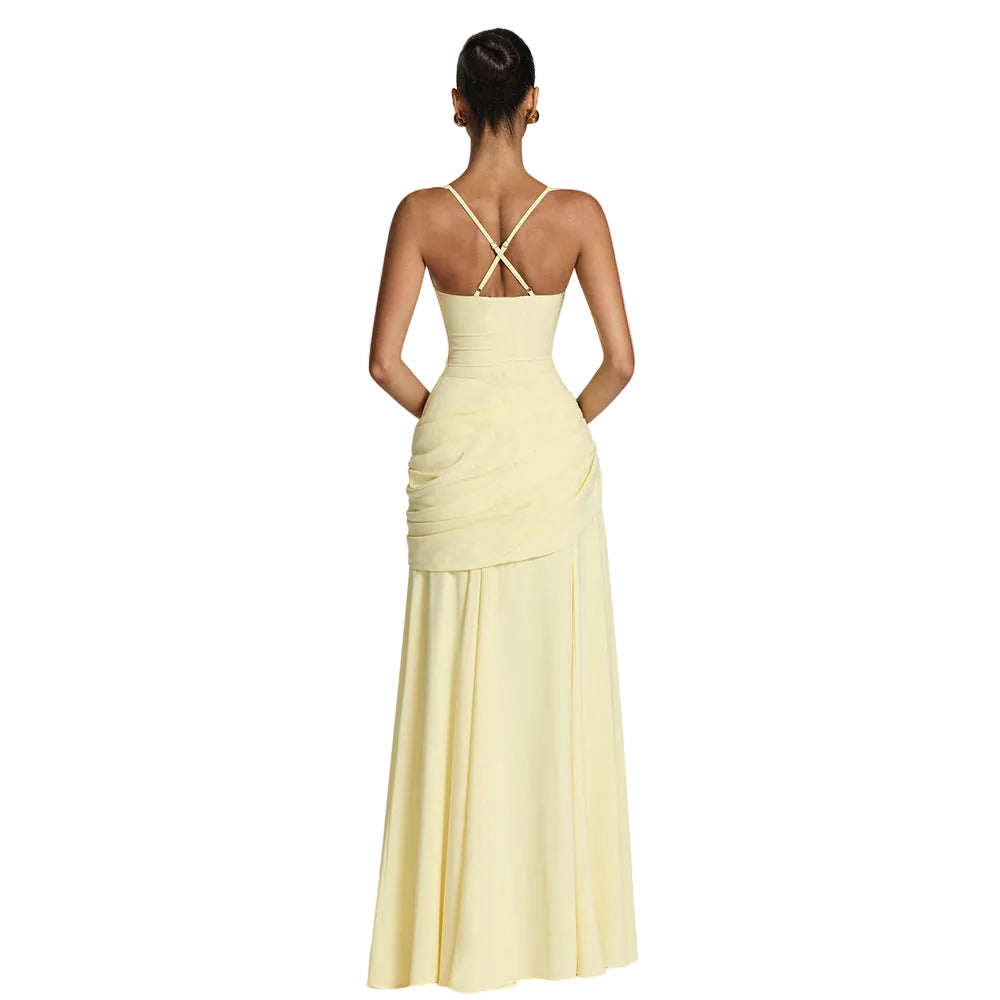 Yellow evening gown with a backless design on a white background