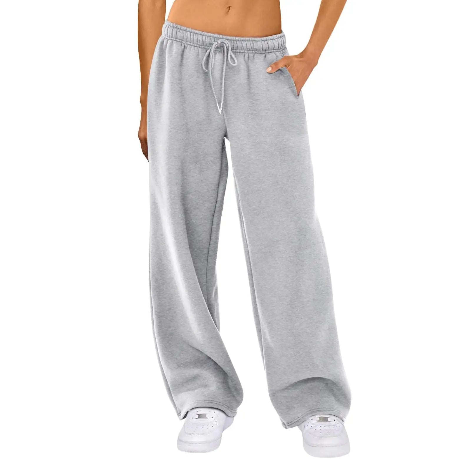 Gray sweatpants worn by a person on a white background