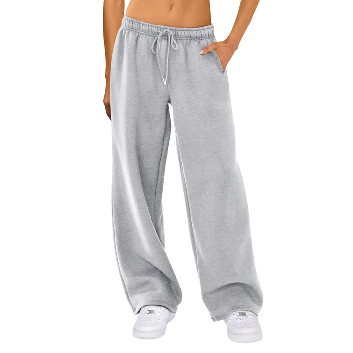 Gray sweatpants worn by a person on a white background