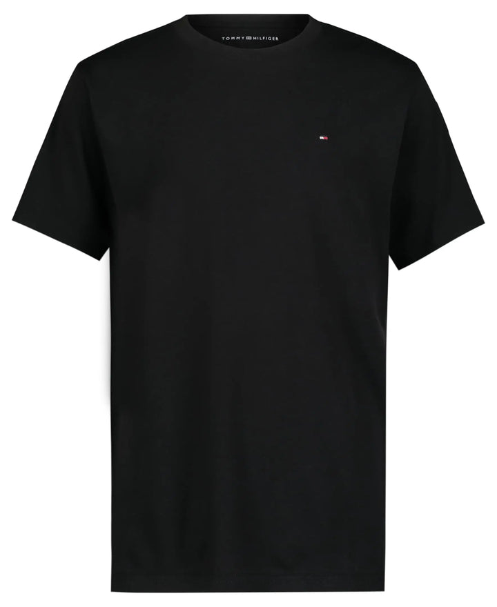 A black short-sleeve crewneck t-shirt by Tommy Hilfiger, featuring the brand's signature small flag logo embroidered on the left chest, displayed against a solid white background.