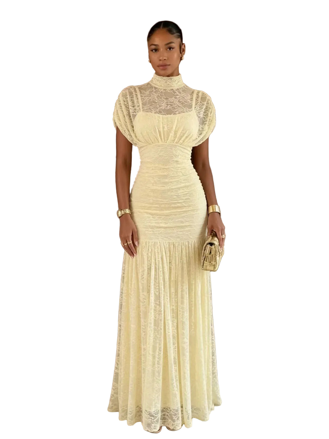 A woman stands indoors wearing a fitted cream lace gown with a high mock neck, short puff sleeves, ruched bodice, and a flared skirt. She is holding a small metallic clutch in front of a dark wood door and beige walls.