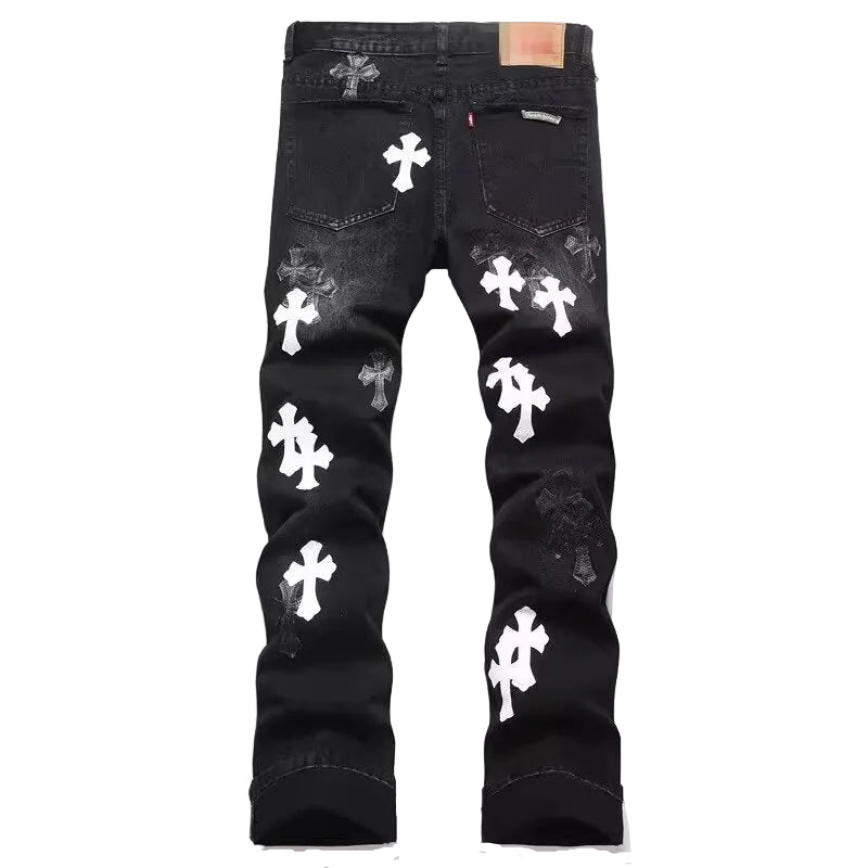 Black denim jeans with multiple white cross patches and distressed details, shown from the back against a plain white background.