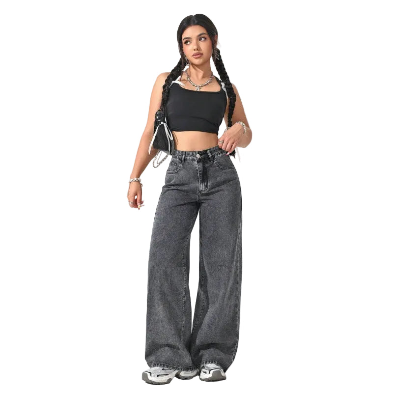 A woman modeling a black square-neck crop top and high-waisted, wide-leg gray denim jeans against a plain white studio background.
