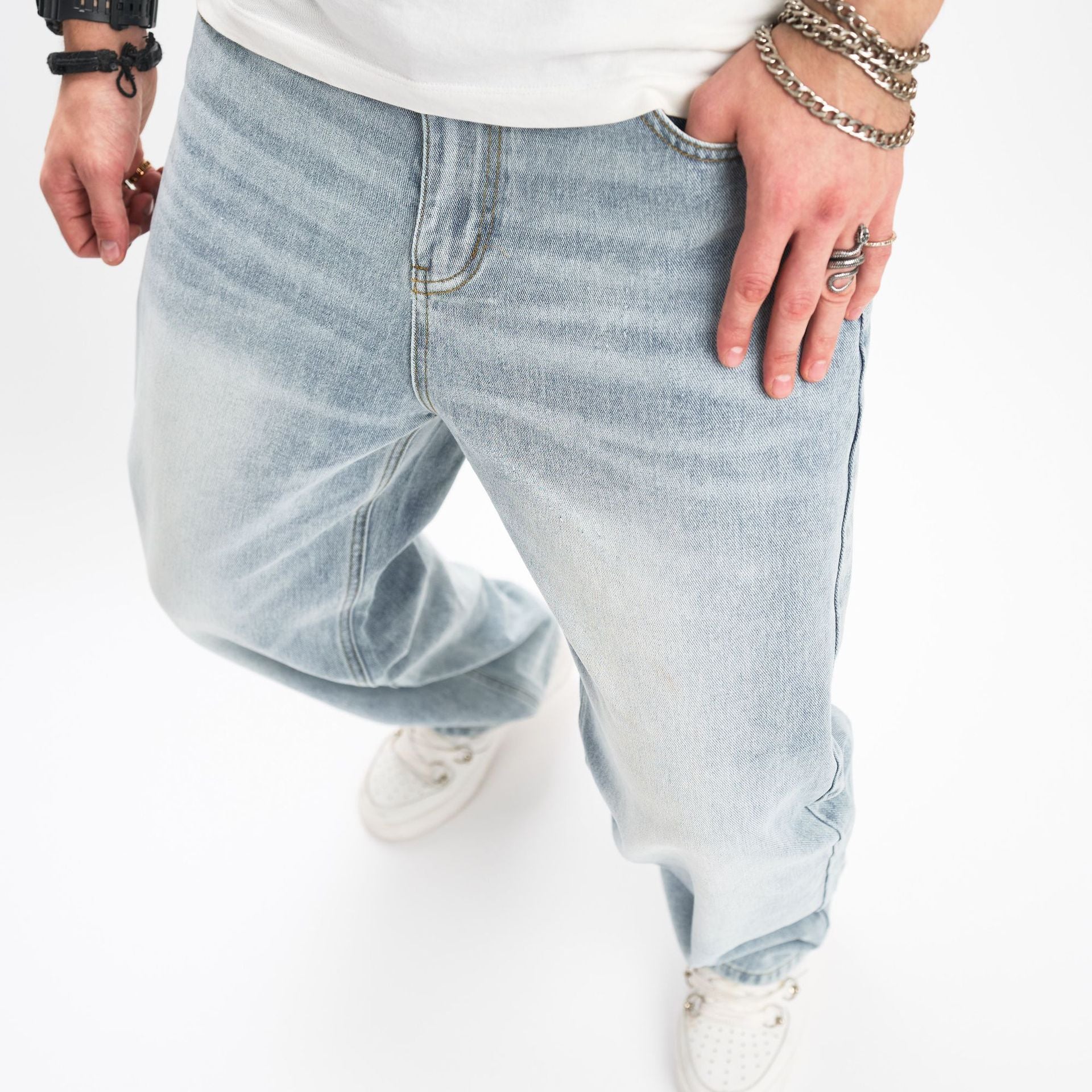 Light blue jeans worn by a person on a white background