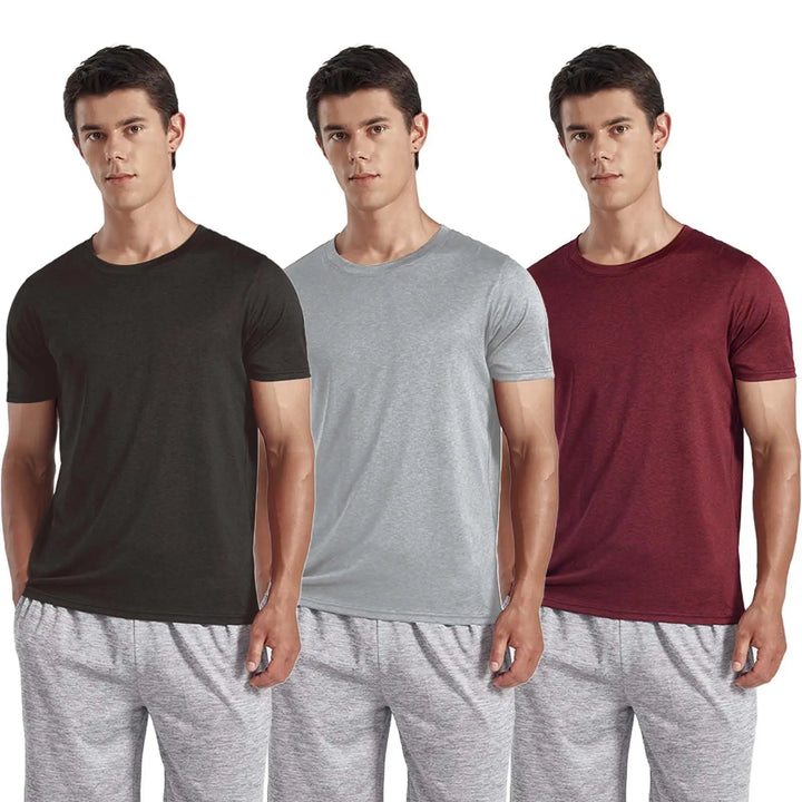 Three men standing side by side wearing matching short-sleeve crew-neck t-shirts in black, light gray, and burgundy, paired with heather gray pants, against a plain white background.