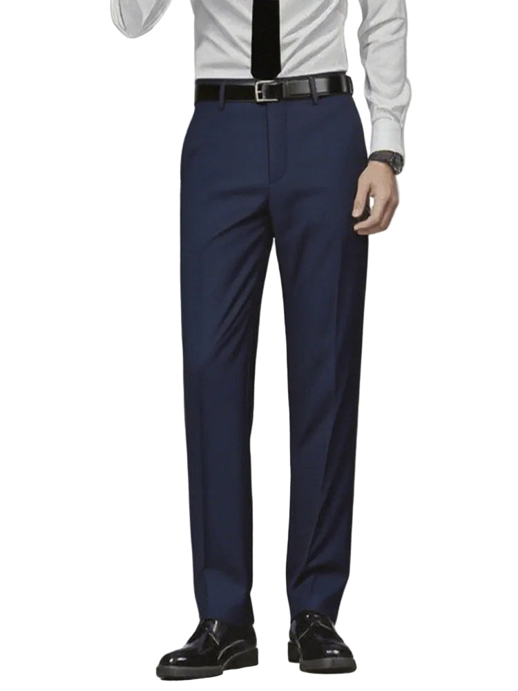 Person wearing navy blue dress pants with a white shirt and black shoes on a gray background