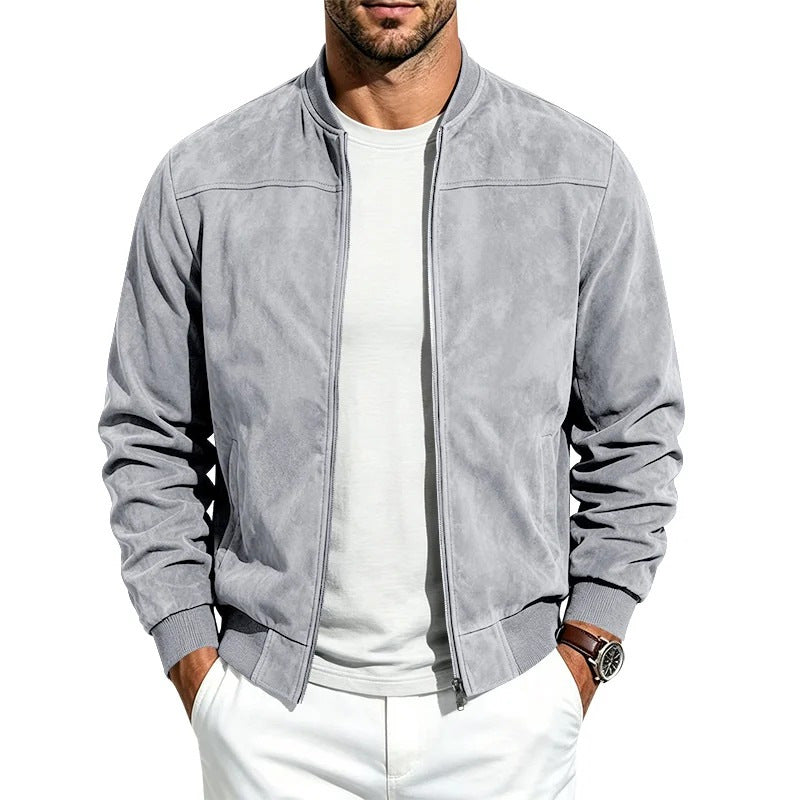 A man wearing a light gray suede-textured zip-up bomber jacket over a white t-shirt and white pants, shown from the chin down against a plain white background.