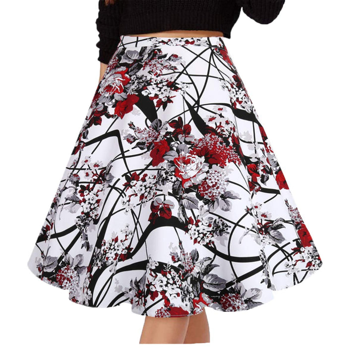 A high-waisted A-line skirt with a white base and a bold abstract floral print in red, black, and gray, shown on a model wearing a black knit top against a plain white background.