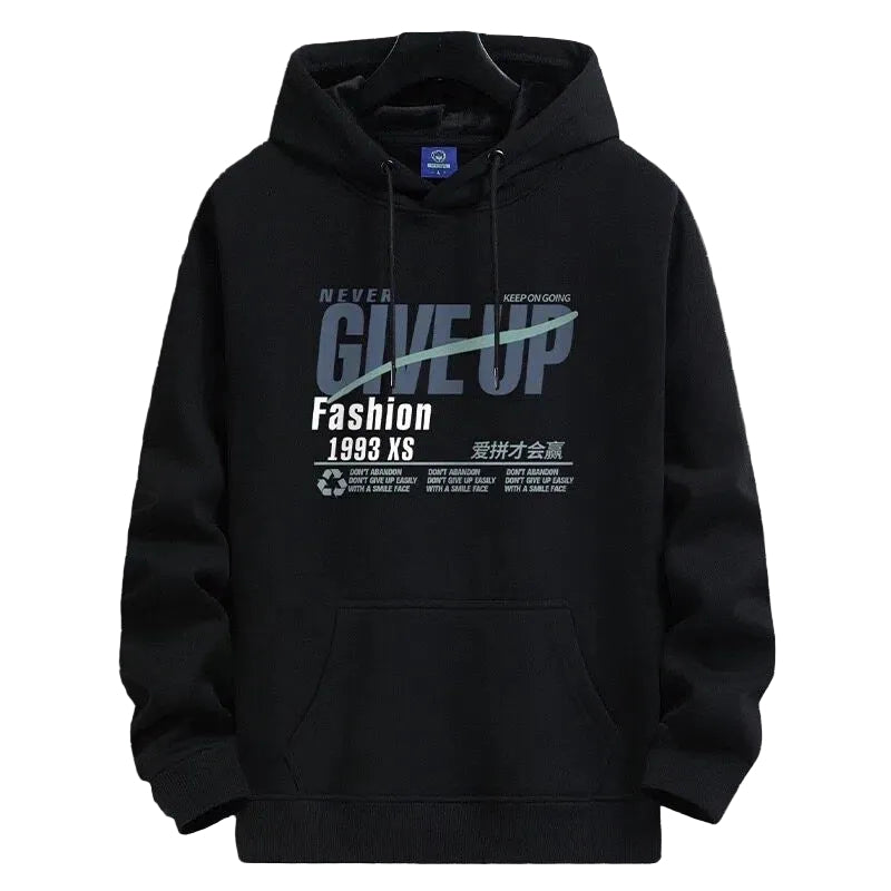 A black pullover hoodie with a graphic print on the front, hanging on a black hanger against a gray grid-patterned background. The graphic features the words 'GIVE UP' in large gray letters with a white diagonal line through it, and 'Fashion 1998 XS' printed below in white.