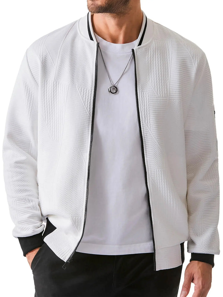 Man wearing a white textured bomber jacket over a white t-shirt on a white background