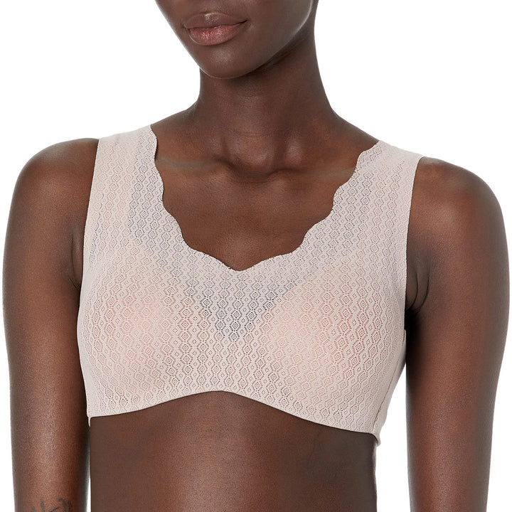 Beige lace bralette worn by a model on a white background