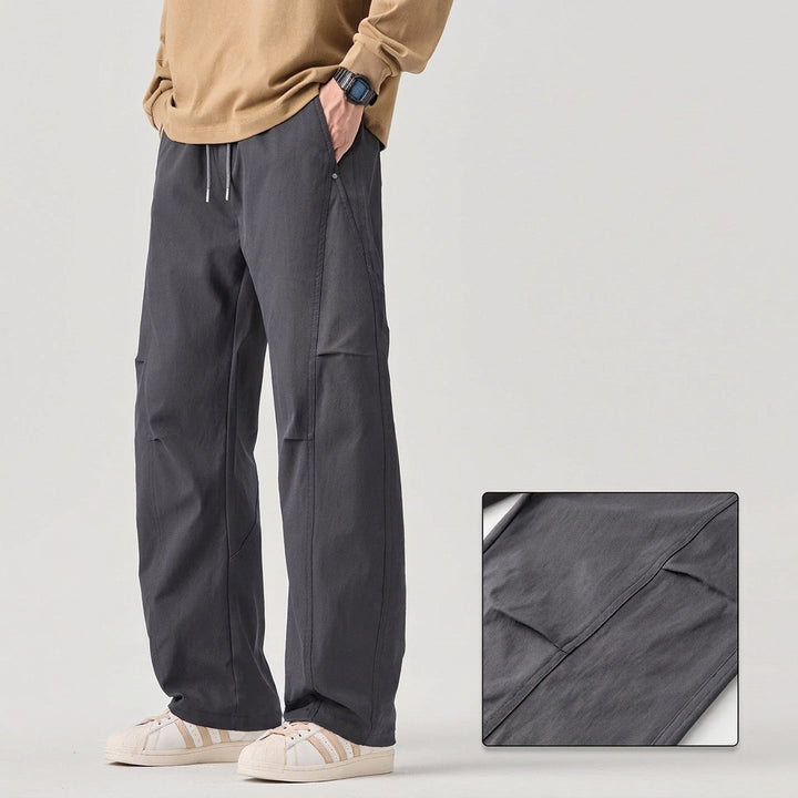 Person wearing gray pants with text on a light gray background