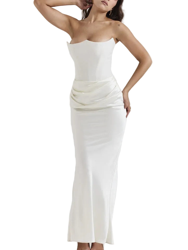 Woman wearing a strapless white dress on a plain background