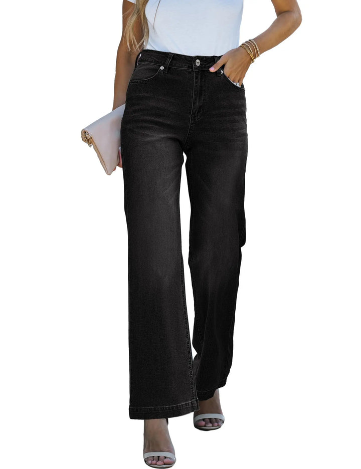 Person wearing black flared jeans on a white background