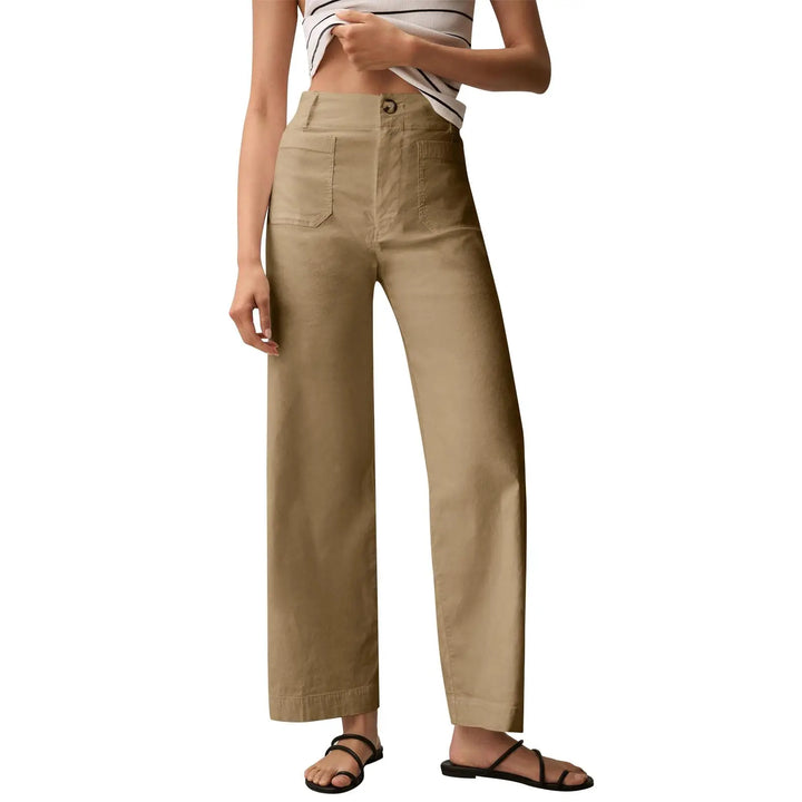 Beige pants worn by a person on a white background