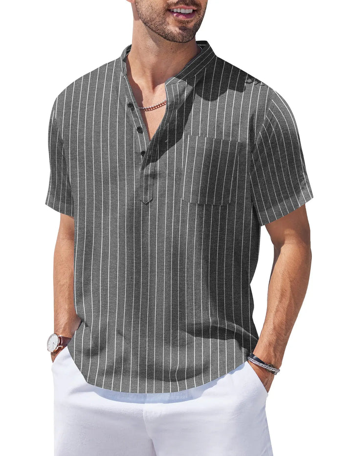 Man wearing a gray striped shirt and white pants on a white background