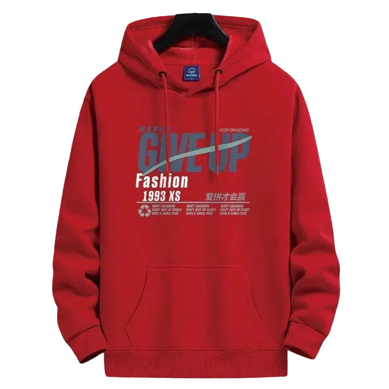 A red pullover hoodie with a graphic print on the front, hanging on a black hanger against a gray grid-patterned background. The graphic features the words 'GIVE UP', 'Fashion', '1993 XS', and Chinese characters.