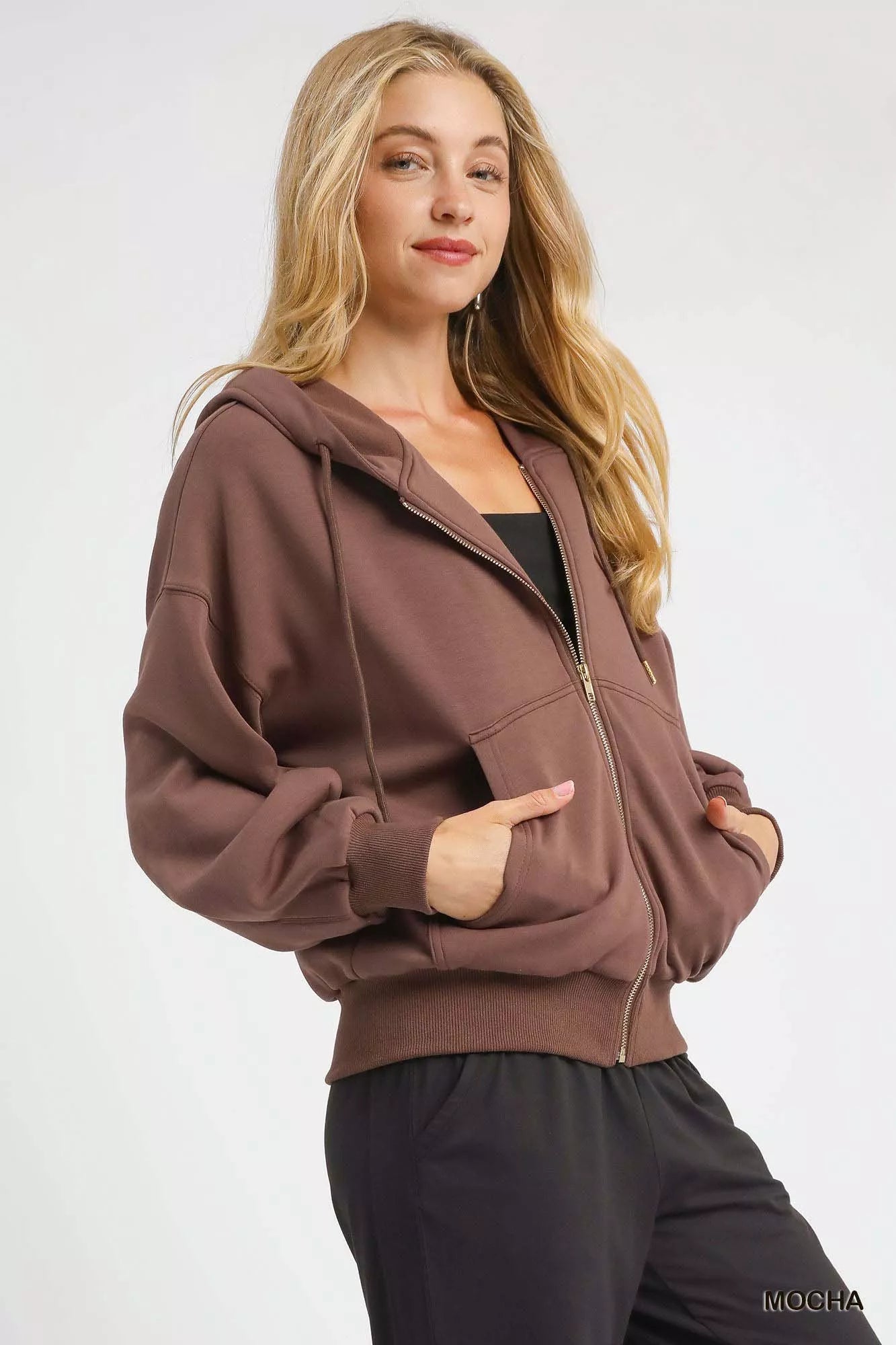 Umgee Zip-Up Fleece Hooded Jacket in mocha color with front pockets and drawstring hood, styled for casual wear.
