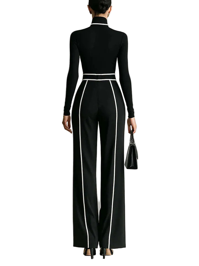 Person wearing a black outfit with white trim on a neutral background