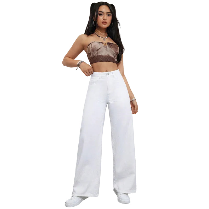 Woman wearing a sheer top and white pants against a plain background