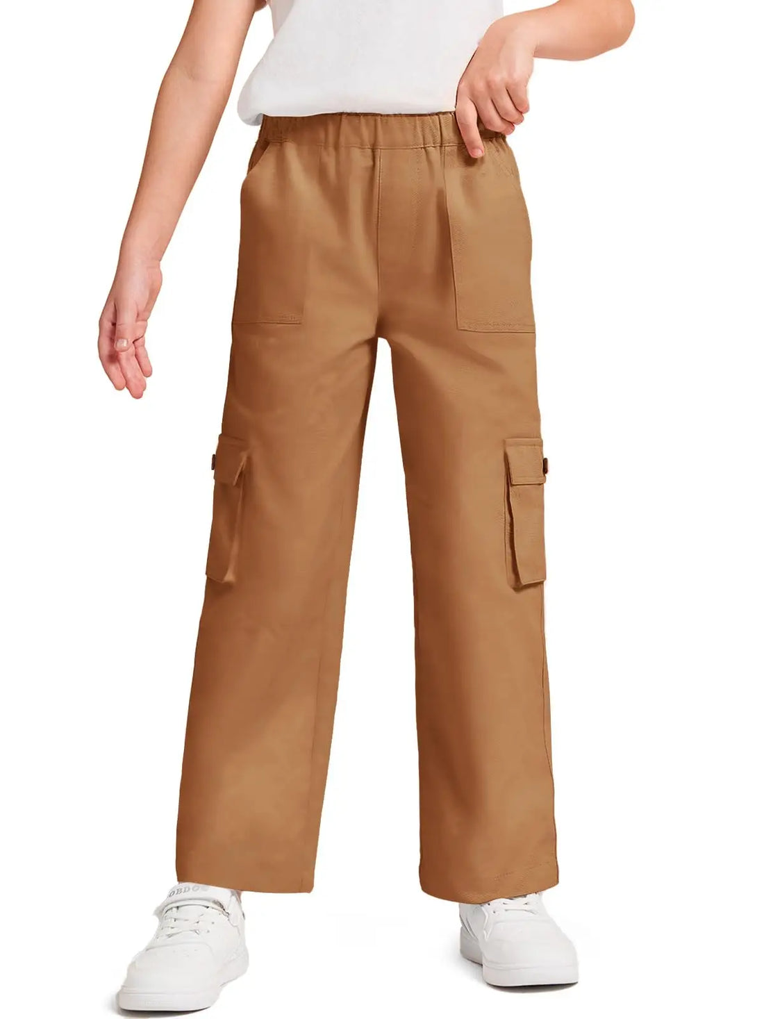 A person wearing tan cargo pants with side flap pockets, paired with a white top and white sneakers, shown against a plain white background.