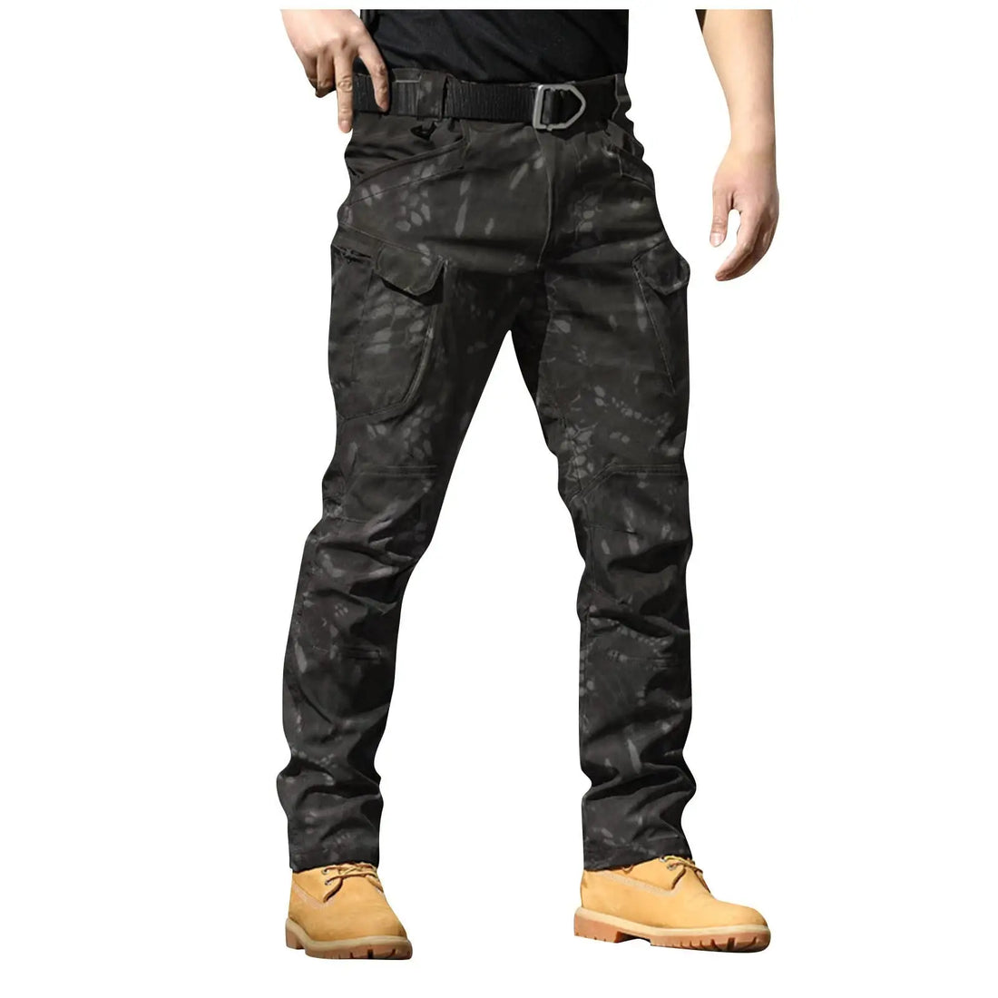 Person wearing black camouflage pants with a belt and tan boots on a white background