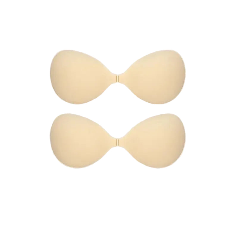 Two beige silicone adhesive bra cups shown on a plain white background.