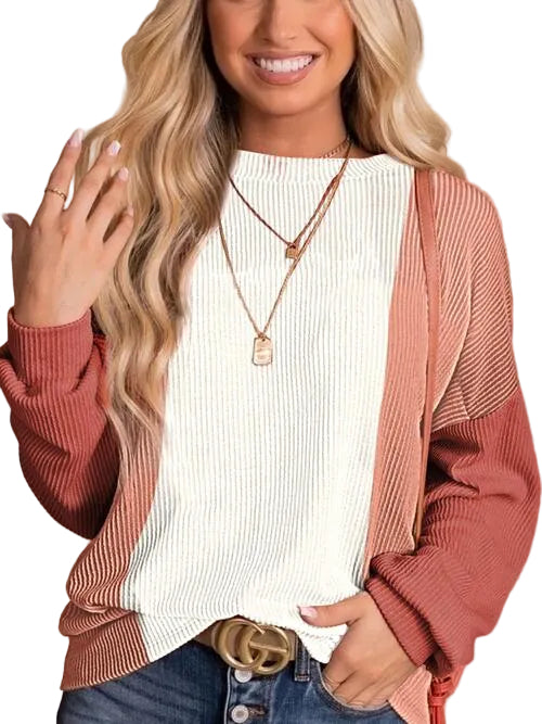 Woman wearing a white top and pink cardigan with a beige background