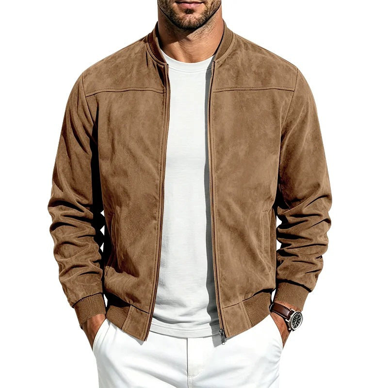A man wearing a brown suede-like bomber jacket over a white t-shirt and white pants, shown from the chin down against a plain white background.