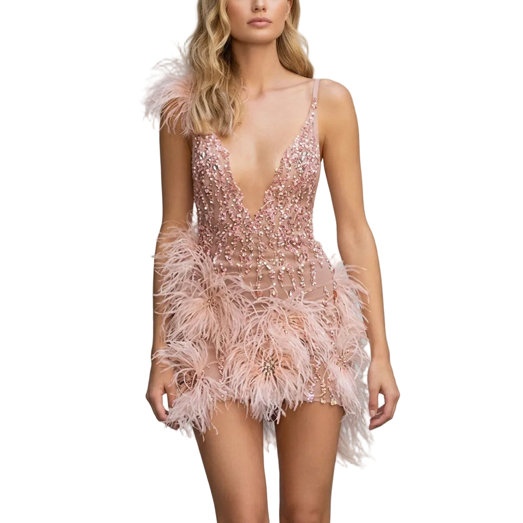 Pink feathered dress with sequin details on a model against a neutral background.