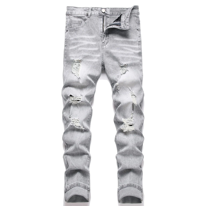 Ripped light blue jeans on a white background