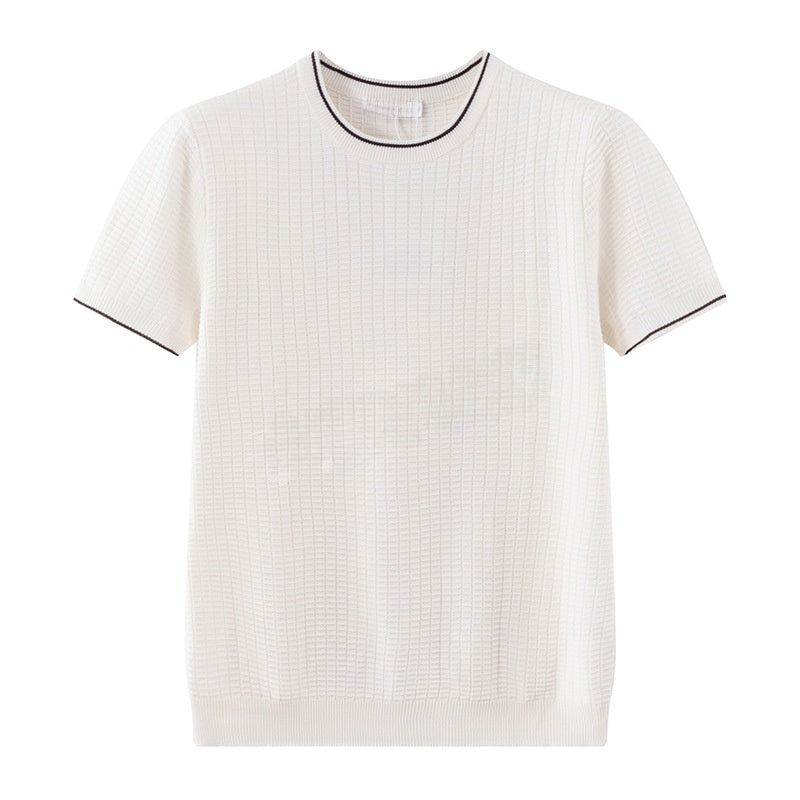 An off-white short-sleeve knit top with a subtle grid texture, featuring black contrast piping along the crew neckline and sleeve cuffs, displayed on a solid white background.