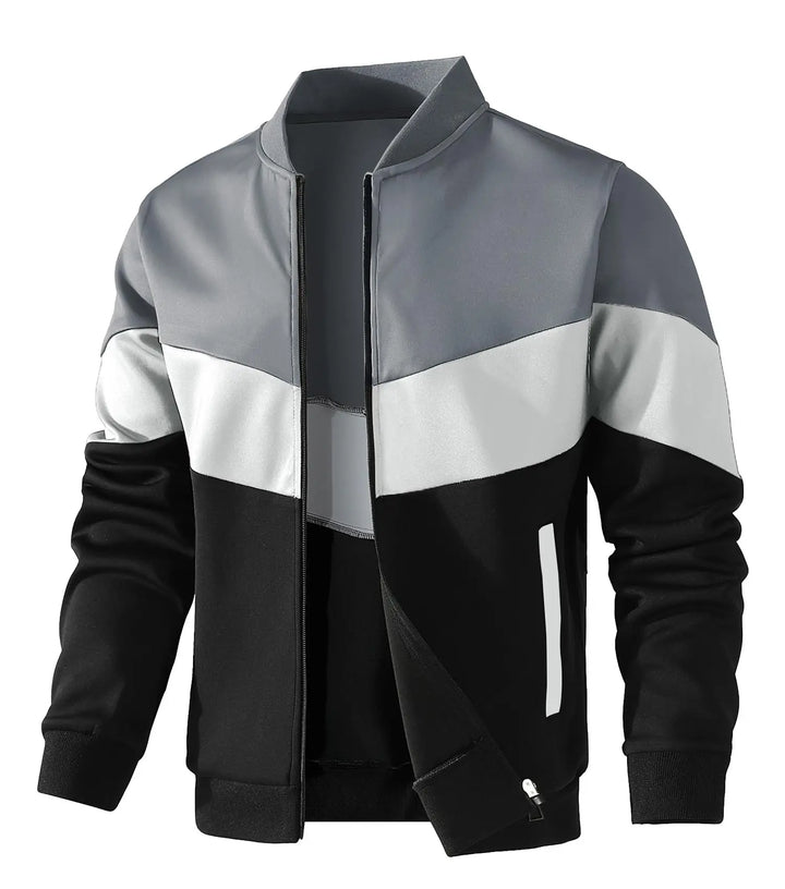 Color-blocked jacket with gray, white, and black sections on a white background