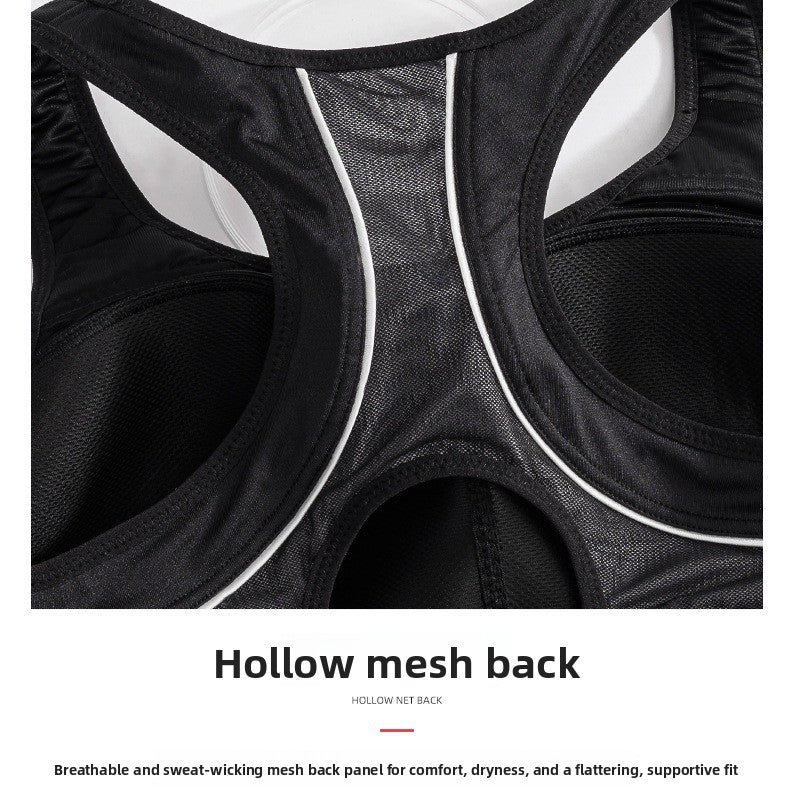 Close-up of the back of a black athletic top or bra with hollow mesh paneling and white piping, with text below reading 'Hollow mesh back'.