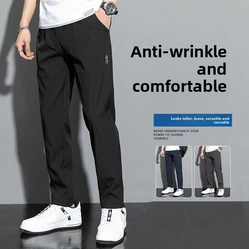 Person wearing black pants with text highlighting anti-wrinkle and comfortable features.