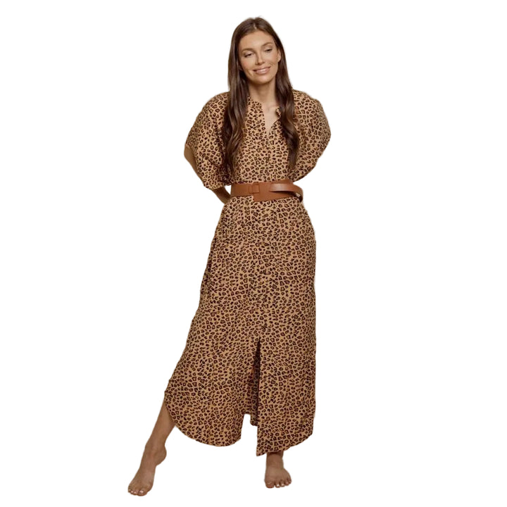 Woman wearing a leopard print outfit with a belt on a beige background