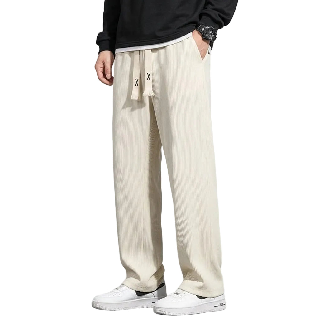 Person wearing beige pants with a brand logo on a white background