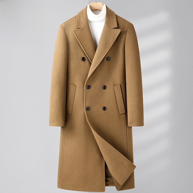 A camel brown double-breasted overcoat with notch lapels and dark buttons, styled over a white turtleneck sweater on a hanger against a light gray background.