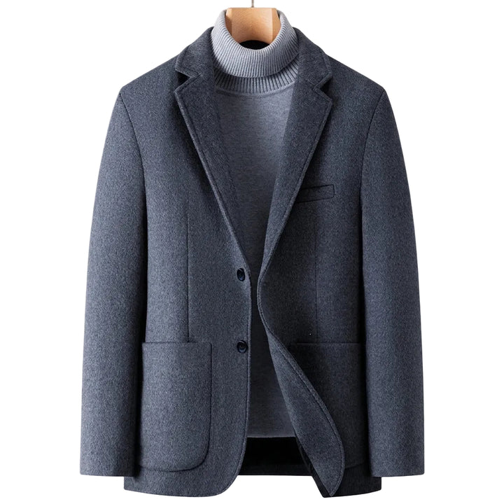A men's dark gray wool-blend blazer styled over a gray ribbed turtleneck sweater, displayed on a wooden hanger against a plain white background.