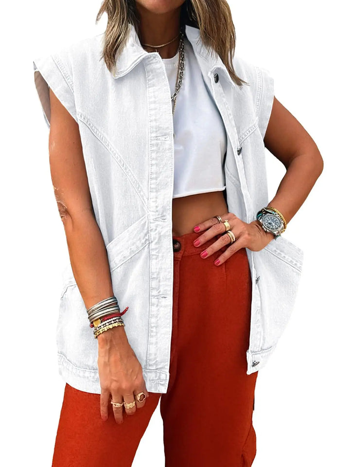 Person wearing a white sleeveless denim jacket over a white crop top and red pants on a white background